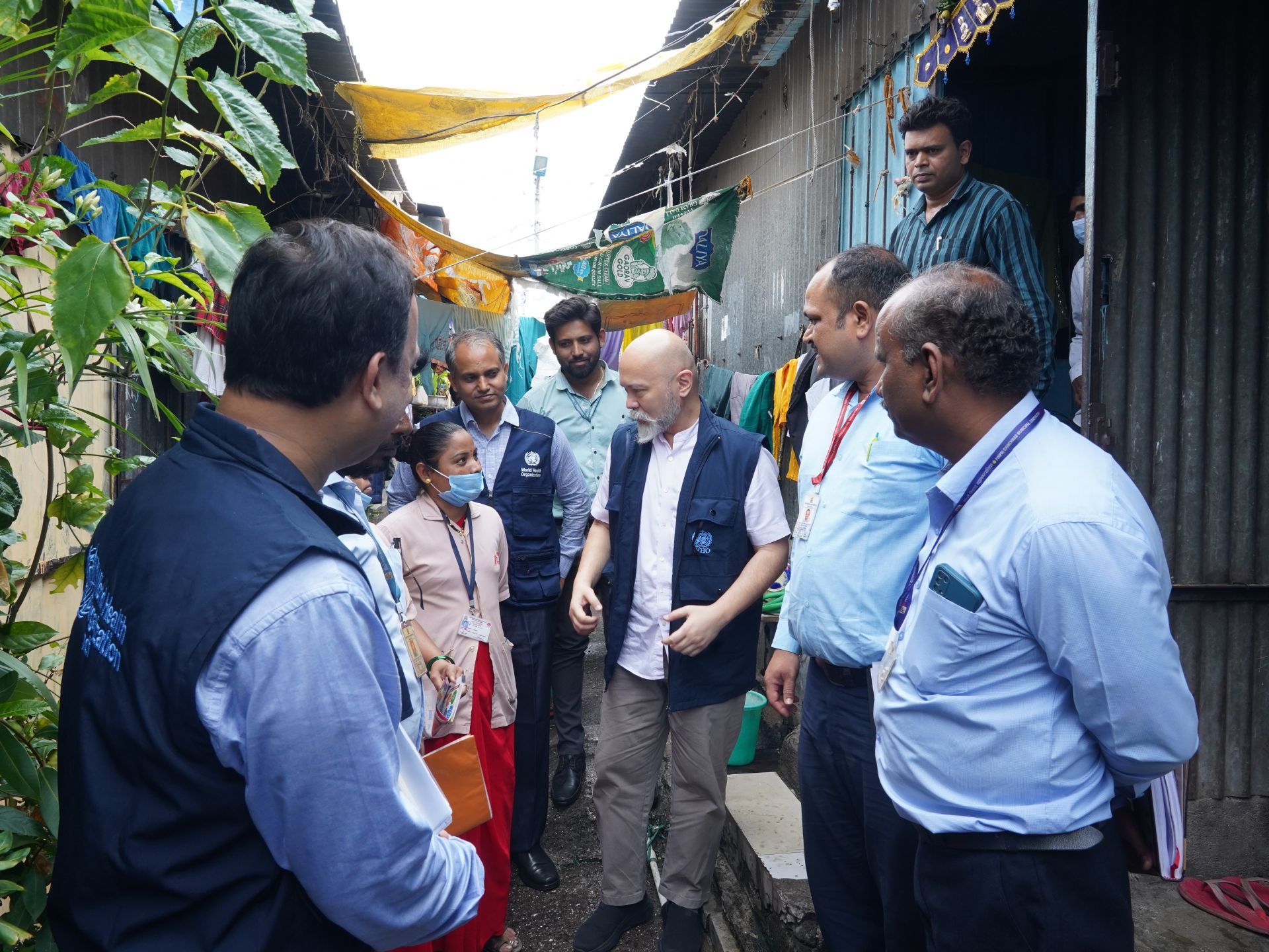 DSC05990 A group of health professionals standing in an outdoor alley, in Pune, India.