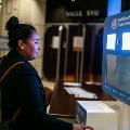 young woman in front of a selfie booth