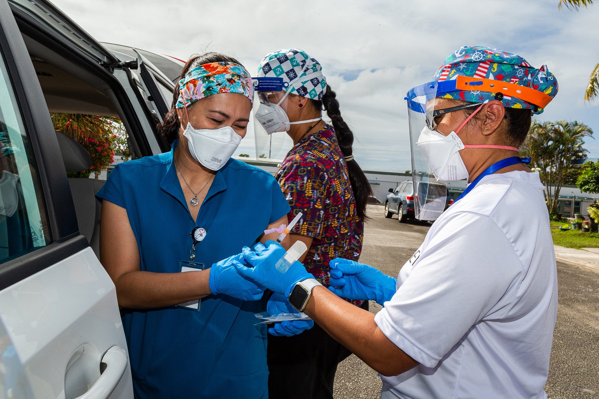 20210205_Guam_Tony Azios_012 (From left) Healthcare workers Lily Mae Concepcion, Teofila Cruz, and Ann Rios of Guam’s Department of Public Health and Social Services and Department of Education prepares COVID-19 vaccines for homebound patients in the village of Sinajana.